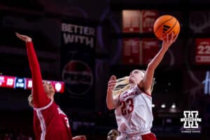 Nebraska Cornhusker guard Britt Prince (23) makes a lay up against Indiana Hoosier forward Maya Makalusky (3) during a college women’s basketball game on Thursday, Jan. 8, 2026, in Lincoln, Nebraska. Photo by John S. Peterson.