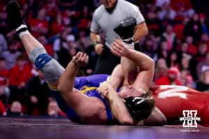 At HWT, Nebraska Cornhusker Harley Andrews tries to pin Northern Iowa Panther Adam Ahrendsen during a college wrestling match. Andrews won by major decision against Ahrendsen 16-7 on Saturday, Jan. 3, 2026, in Lincoln, Nebraska. Photo by John S. Peterson.