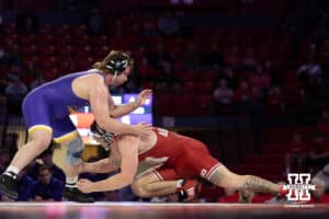 At HWT, Nebraska Cornhusker Harley Andrews shoots for a leg against Northern Iowa Panther Adam Ahrendsen during a college wrestling match. Andrews won by major decision against Ahrendsen 16-7 on Saturday, Jan. 3, 2026, in Lincoln, Nebraska. Photo by John S. Peterson.