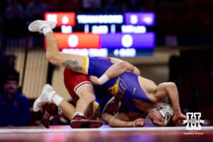At 149, Nebraska #12 Chance Lamer drives Northern Iowa's Ethan Basile head in to the matt during a college wrestling match on Saturday, Jan. 3, 2026, in Lincoln, Nebraska. Lamer wins by technical fall. Photo by John S. Peterson.