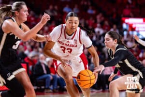 Nebraska Cornhusker forward Amiah Hargrove (33) drives between two Purdue Boilermakers defenders during a college women’s basketball game on Sunday, Jan. 4, 2026, in Lincoln, Nebraska. Photo by John S. Peterson.