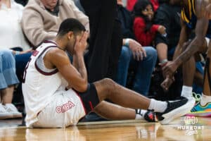 Omaha Maverick Grant Stubblefield (3) sits upset after a foul during a basketball game against Kansas City on Saturday, Jan 3, 2026, in Omaha, Nebraska. Photo by Brandon Tiedemann.