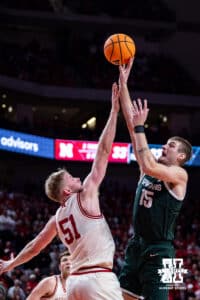 Nebraska Cornhusker forward Jared Garcia (15) reaches to try an block Michigan State Spartan center Carson Cooper (15) in the second half during a college basketball game on Friday, Jan. 2, 2026, in Lincoln, Nebraska. Photo by John S. Peterson.