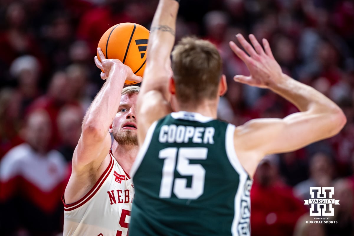 Nebraska Men’s Basketball | Hail Varsity Nebraska Cornhusker forward Rienk Mast (51) makes a three point shot against Michigan State Spartan center Carson Cooper (15) in the first half during a college basketball game on Friday, Jan. 2, 2026, in Lincoln, Nebraska. Photo by John S. Peterson.
