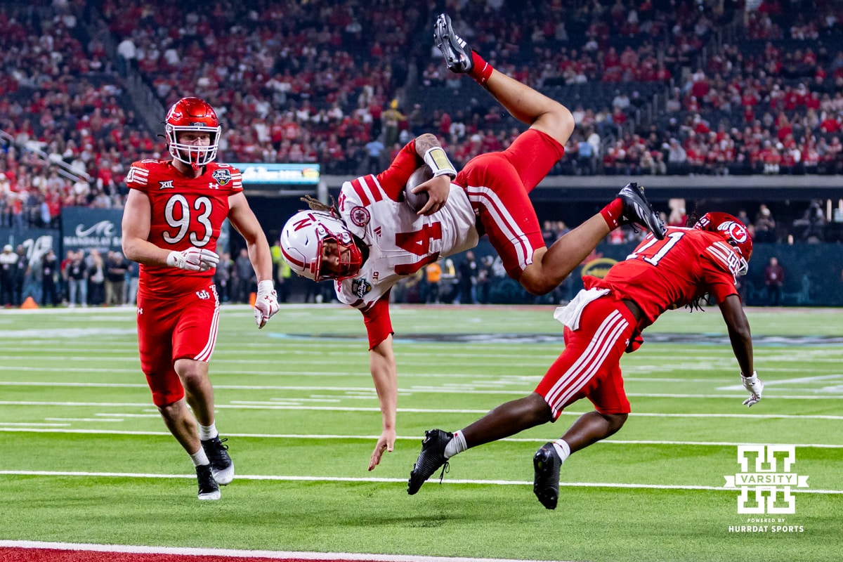 Nebraska Cornhusker quarterback TJ Lateef (14) dives over Utah Ute safety Rabbit Evans (1) to score a touchdown during the Las Vegas Bowl game on Wednesday, Dec. 31, 2025, in Las Vegas, NV. Photo by John S. Peterson.