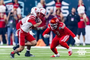 Nebraska Cornhusker quarterback TJ Lateef (14) runs witht the ball against Utah Ute linebacker Levani Damuni (3) during the Las Vegas Bowl game on Wednesday, Dec. 31, 2025, in Las Vegas, NV. Photo by John S. Peterson.