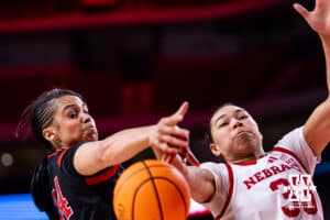 Nebraska Cornhusker forward Amiah Hargrove (33) and Rutgers Scarlet Knight forward Janae Walker (44) reach for the ball during a women’s basketball game on Saturday, Feb. 28, 2026, in Lincoln, Nebraska. Photo by John S. Peterson.