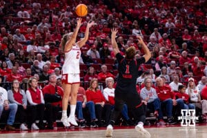Nebraska Cornhusker guard Logan Nissley (2) makes a three point basket against Rutgers Scarlet Knight guard Lauryn Swann (1) in the first quarter during a women’s basketball game on Saturday, Feb. 28, 2026, in Lincoln, Nebraska. Photo by John S. Peterson.