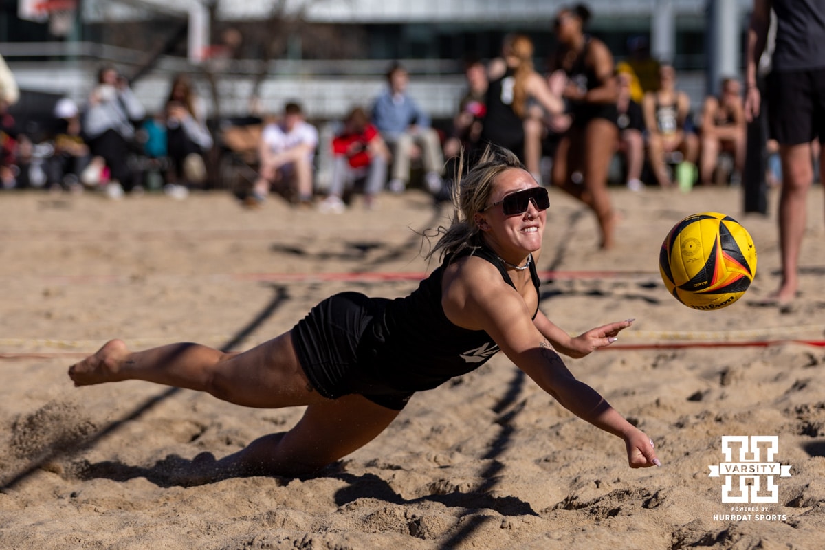 Nebraska Cornhusker Laney Choboy (9) dives to dig the ball against the Wayne State Wildcats during a beach volleyball match on Friday, Feb. 27, 2026, in Lincoln, Nebraska. Photo by John S. Peterson.