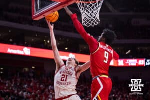 Nebraska Cornhusker forward Pryce Sandfort (21) makes a lay up against Maryland Terrapin forward Solomon Washington (9) in the first half during a college basketball game on Wednesday, Feb. 25, 2026, in Lincoln, Nebraska.