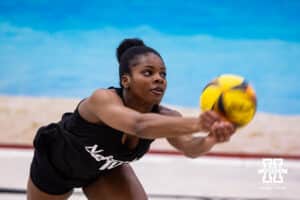 Nebraska Cornhusker Keoni Williams (10) digs the ball against the Ottawa Braves during a college beach volleyball match on Monday, Feb. 23, 2026, in Lincoln, NE. Photo by John S. Peterson.