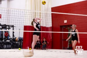 Nebraska Cornhusker Campbell Flynn (24) spikes the ball against the Ottawa Braves during a college beach volleyball match on Monday, Feb. 23, 2026, in Lincoln, NE. Photo by John S. Peterson.