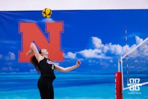 Nebraska Cornhusker Virginia Adriano (19) spikes the ball against the Ottawa Braves during a college beach volleyball match on Monday, Feb. 23, 2026, in Lincoln, NE. Photo by John S. Peterson.