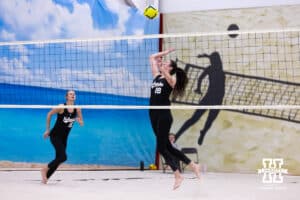 Nebraska Cornhusker Virginia Adriano (19) spikes the ball against the Ottawa Braves during a college beach volleyball match on Monday, Feb. 23, 2026, in Lincoln, NE. Photo by John S. Peterson.