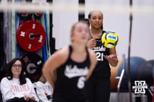 Nebraska Cornhusker Manaia Ogbechie (21) looks for the signal from Keri Leimbach (6) before serving against the Ottawa Braves during a college beach volleyball match on Monday, Feb. 23, 2026, in Lincoln, NE. Photo by John S. Peterson.