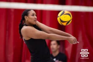 Nebraska Cornhusker Manaia Ogbechie (21) passes the ball against the Ottawa Braves during a college beach volleyball match on Monday, Feb. 23, 2026, in Lincoln, NE. Photo by John S. Peterson.