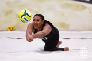Nebraska Cornhusker Manaia Ogbechie (21) dives for a dig against the Ottawa Braves during a college beach volleyball match on Monday, Feb. 23, 2026, in Lincoln, NE. Photo by John S. Peterson.