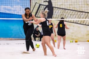 Nebraska Cornhuskers Manaia Ogbechie (21) and Keri Leimbach (6) give each other fives against the Ottawa Braves during a college beach volleyball match on Monday, Feb. 23, 2026, in Lincoln, NE. Photo by John S. Peterson.