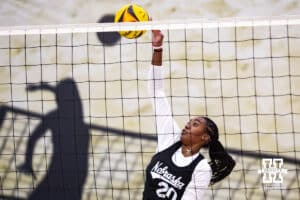 Nebraska Cornhusker Jayden Robinson (20) spikes the ball against the Ottawa Braves during a college beach volleyball match on Monday, Feb. 23, 2026, in Lincoln, NE. Photo by John S. Peterson.