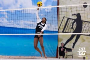 Nebraska Cornhusker Jayden Robinson (20) spikes the ball against the Ottawa Braves during a college beach volleyball match on Monday, Feb. 23, 2026, in Lincoln, NE. Photo by John S. Peterson.