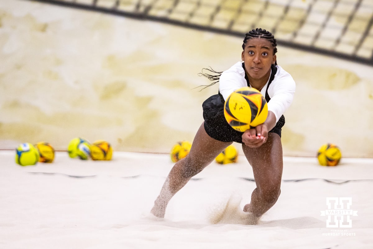 Nebraska Cornhusker Jayden Robinson (20) digs the ball against the Ottawa Braves during a college beach volleyball match on Monday, Feb. 23, 2026, in Lincoln, NE. Photo by John S. Peterson.