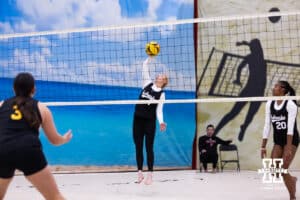 Olivia Mauch (1) spikes the ball over the net against the Ottawa Braves during a college beach volleyball match on Monday, Feb. 23, 2026, in Lincoln, NE. Photo by John S. Peterson.