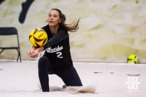 Nebraska Cornhusker Harper Murray (2) digs the ball against the Ottawa Braves during a college beach volleyball match on Monday, Feb. 23, 2026, in Lincoln, NE. Photo by John S. Peterson.