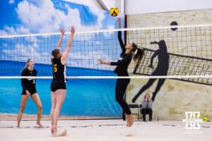 Nebraska Cornhusker Harper Murray (2) spikes the ball against the Ottawa Braves during a college beach volleyball match on Monday, Feb. 23, 2026, in Lincoln, NE. Photo by John S. Peterson.