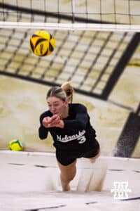 Nebraska Cornhusker Andi Jackson (3) dives for the ball against the Ottawa Braves during a college beach volleyball match on Monday, Feb. 23, 2026, in Lincoln, NE. Photo by John S. Peterson.