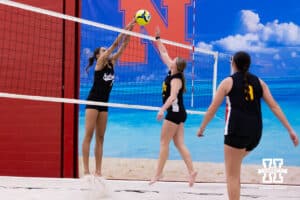 Nebraska Cornhusker Skyler Pierce (7) tips the ball against the Ottawa Braves during a college beach volleyball match on Monday, Feb. 23, 2026, in Lincoln, NE. Photo by John S. Peterson.