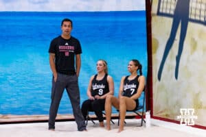 Nebraska Cornhusker head beach coach Jaylen Reyes with Laney Choboy (9) and Skyler Pierce (7) waiting to take on the Ottawa Braves during a college beach volleyball match on Monday, Feb. 23, 2026, in Lincoln, NE. Photo by John S. Peterson.