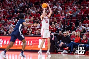 Nebraska Cornhusker forward Pryce Sandfort (21) makes a three point basket against Penn State Nittany Lion guard Kayden Mingo (4) in the second half during a college basketball game on Saturday, Feb. 21, 2026, in Lincoln, NE. Photo by John S. Peterson.