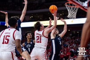Nebraska Cornhusker forward Pryce Sandfort (21) makes a lay up against Penn State Nittany Lion forward Ivan Juric (3) in the second half during a college basketball game on Saturday, Feb. 21, 2026, in Lincoln, NE. Photo by John S. Peterson.