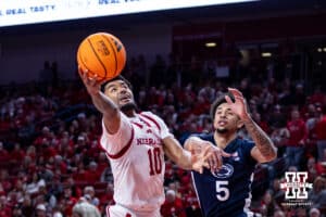 Nebraska Cornhusker guard Jamarques Lawrence (10) makes a lay up against Penn State Nittany Lion guard Freddie Dilione V. (5) in the second half during a college basketball game on Saturday, Feb. 21, 2026, in Lincoln, NE. Photo by John S. Peterson.