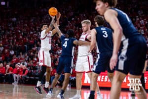 Nebraska Cornhusker guard Jamarques Lawrence (10) makes a three point basket against Penn State Nittany Lion guard Kayden Mingo (4) in the second half during a college basketball game on Saturday, Feb. 21, 2026, in Lincoln, NE. Photo by John S. Peterson.