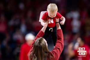 Mom picks her baby after he won the halftime baby race during a college basketball game between the Nebraska Cornhuskers and the Penn State Nittany Lions on Saturday, Feb. 21, 2026, in Lincoln, NE. Photo by John S. Peterson.
