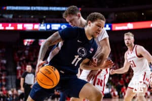 Penn State Nittany Lion guard Eli Rice (11) drives into Nebraska Cornhusker guard Cale Jacobsen (31) in the first half during a college basketball game on Saturday, Feb. 21, 2026, in Lincoln, NE. Photo by John S. Peterson.