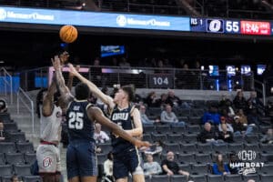 Omaha Mavericks Ja'Sean Glover (5) shoots over two defenders during a college basketball game against Oral Roberts on Feb 18, 2026, in Omaha, Nebraska. Photo by Brandon Tiedemann