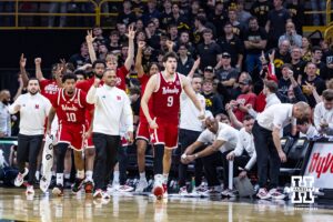 Nebraska Cornhuskers bench reacts to a three point basket by Cale Jacobsen against the Iowa Hawkeyes in the first half during a college basketball game on Tuesday, Feb. 17, 2026, in Iowa City, Iowa. Photo by John S. Peterson.