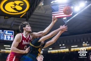 Nebraska Cornhusker forward Berke Buyuktuncel (9) reaches for a rebound against Iowa Hawkeye forward Alvaro Folgueiras (7) in the first half during a college basketball game on Tuesday, Feb. 17, 2026, in Iowa City, Iowa. Photo by John S. Peterson.