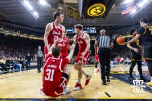 Nebraska Cornhusker guard Cale Jacobsen (31) gets a helping hand from Pryce Sandfort and Sam Hoiberg in the first half against the Iowa Hawkeyes during a college basketball game on Tuesday, Feb. 17, 2026, in Iowa City, Iowa. Photo by John S. Peterson.
