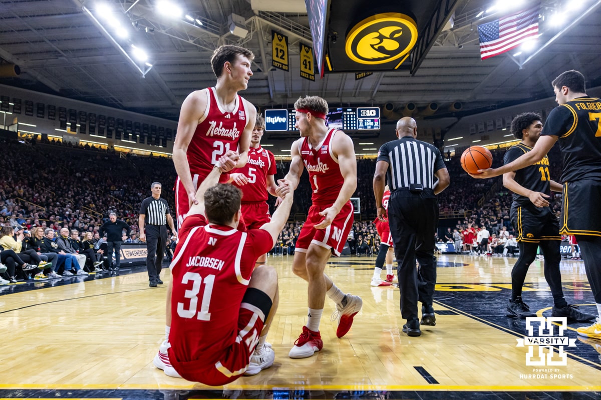 Nebraska Cornhusker guard Cale Jacobsen (31) gets a helping hand from Pryce Sandfort and Sam Hoiberg in the first half against the Iowa Hawkeyes during a college basketball game on Tuesday, Feb. 17, 2026, in Iowa City, Iowa. Photo by John S. Peterson.