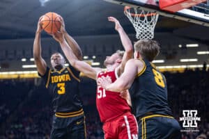 Nebraska Cornhusker forward Rienk Mast (51) reaches for the rebound against Iowa Hawkeye forward Cam Manyawu (3) during a college basketball game on Tuesday, Feb. 17, 2026, in Iowa City, Iowa. Photo by John S. Peterson.
