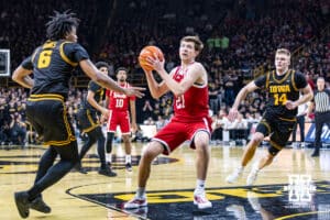 Nebraska Cornhusker forward Pryce Sandfort (21) makes a lay up against Iowa Hawkeye guard Tavion Banks (6) in the first half during a college basketball game on Tuesday, Feb. 17, 2026, in Iowa City, Iowa. Photo by John S. Peterson.