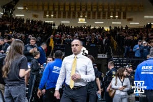 Iowa Hawkeye head coach Ben McCollum walks out to the court to take on the Nebraska Cornhuskers during a college basketball game on Tuesday, Feb. 17, 2026, in Iowa City, Iowa. Photo by John S. Peterson.