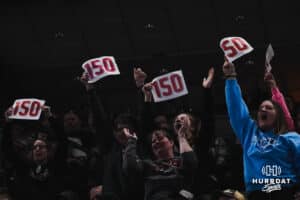 Cozad fans hold up signs during Nebraska Girls Wrestling Quarterfinals on Feb 17, 2026, in Omaha, Nebraska. Photo by Brandon Tiedemann
