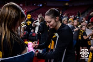 Iowa Hawkeye guard Taylor McCabe (2) signs a cast for a fans after the game against the Nebraska Cornhuskers during a college basketball game on Monday, Feb. 16, 2026, in Lincoln, Nebraska. Photo by John S. Peterson.