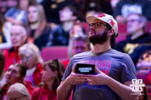 Nebraska Cornhusker fan holds up a sign on the his phone against the Iowa Hawkeyes during a college basketball game on Monday, Feb. 16, 2026, in Lincoln, Nebraska. Photo by John S. Peterson.