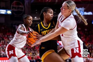Nebraska Cornhusker forward Emily Fisher (34) and Hailey Weaver reaches for the ball against the Iowa Hawkeyes in the first quarter during a college basketball game on Monday, Feb. 16, 2026, in Lincoln, Nebraska. Photo by John S. Peterson.