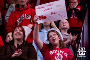 Nebraska Cornhusker fan holding a sign before the game against the Iowa Hawkeyes during a college basketball game on Monday, Feb. 16, 2026, in Lincoln, Nebraska. Photo by John S. Peterson.